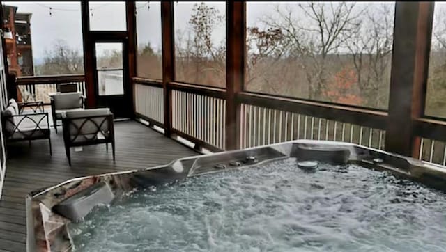 sunroom / solarium with a hot tub