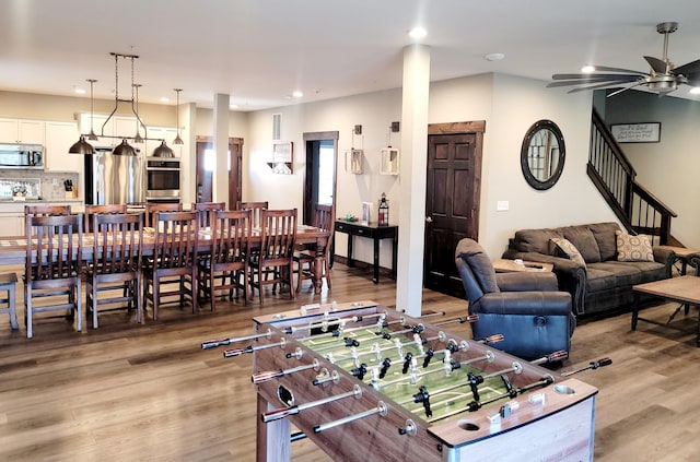 living room featuring light hardwood / wood-style floors and ceiling fan