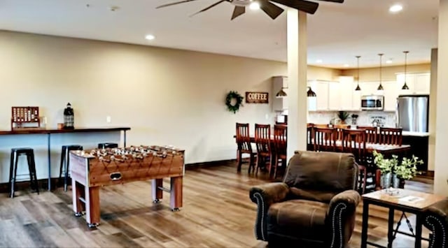 playroom with wood-type flooring and ceiling fan