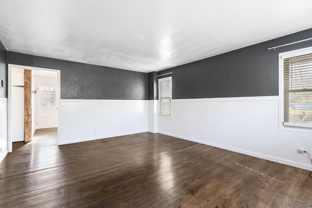 unfurnished room with dark hardwood / wood-style floors