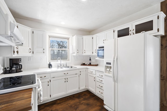 kitchen featuring sink, white refrigerator with ice dispenser, stove, white cabinets, and dark hardwood / wood-style floors