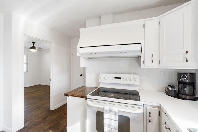 kitchen featuring dark hardwood / wood-style floors, range hood, white range with electric stovetop, white cabinets, and ceiling fan