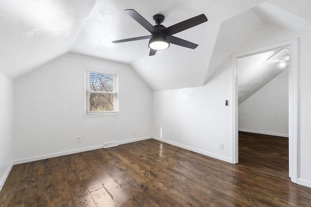 additional living space featuring ceiling fan, dark wood-type flooring, and vaulted ceiling