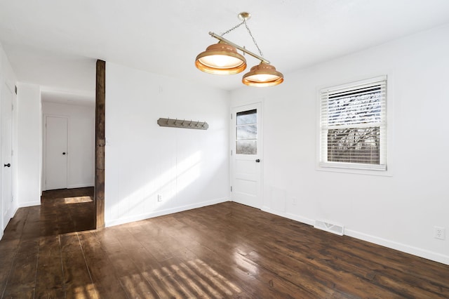 unfurnished room with dark hardwood / wood-style flooring