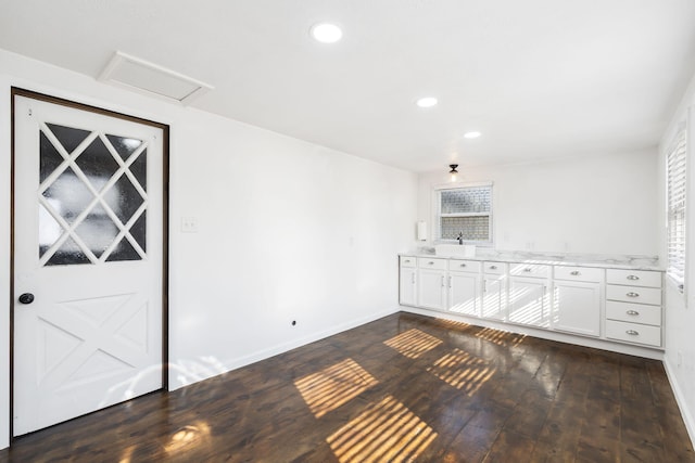 interior space featuring white cabinets and dark hardwood / wood-style flooring