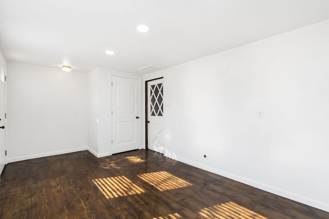 spare room with dark wood-type flooring