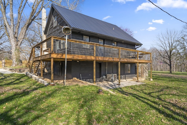 back of property featuring central AC unit, a deck, a patio area, and a lawn