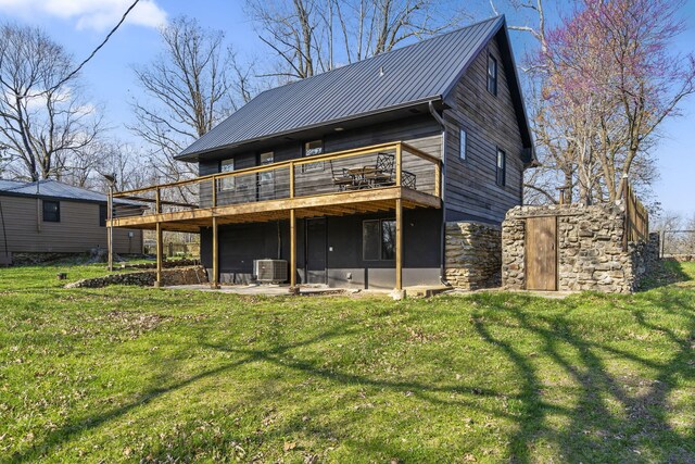 back of property with a patio area, a deck, a lawn, and cooling unit