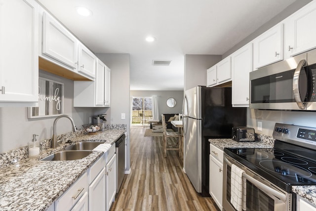 kitchen featuring white cabinets, appliances with stainless steel finishes, and sink