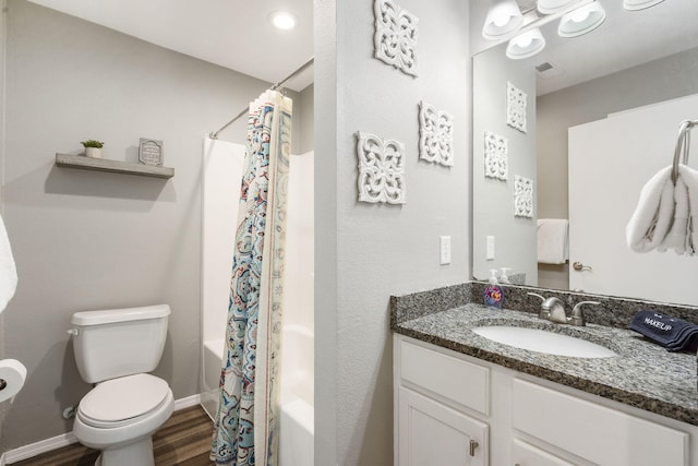 full bathroom with hardwood / wood-style floors, shower / bath combo, vanity, and toilet