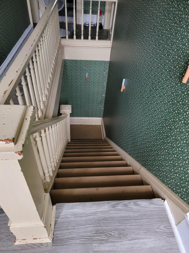 stairs with hardwood / wood-style flooring