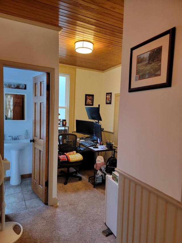 carpeted home office with wood ceiling