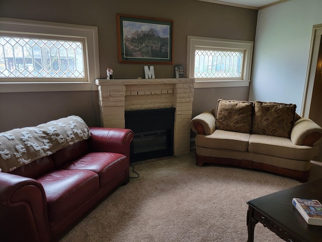 living room with a brick fireplace, crown molding, carpet flooring, and a wealth of natural light