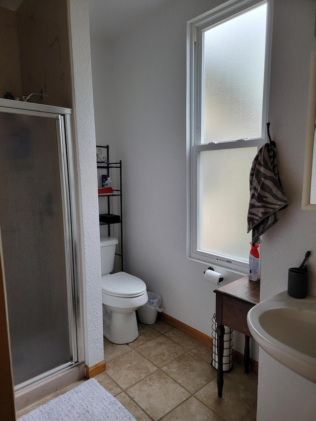 bathroom with an enclosed shower, tile patterned floors, and toilet