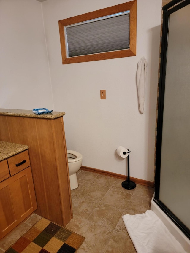 bathroom with vanity, toilet, and an enclosed shower