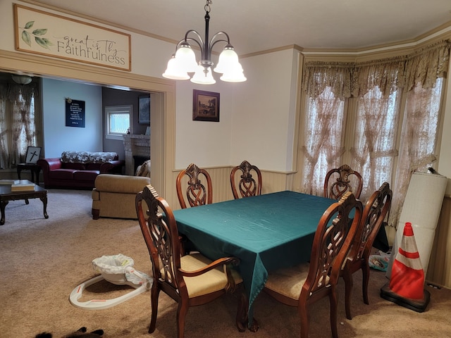 carpeted dining room featuring a notable chandelier and crown molding