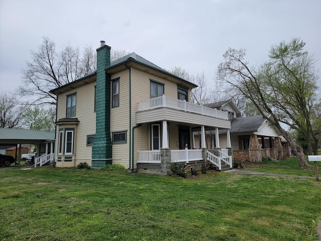 view of side of home with a carport, a porch, a yard, and a balcony