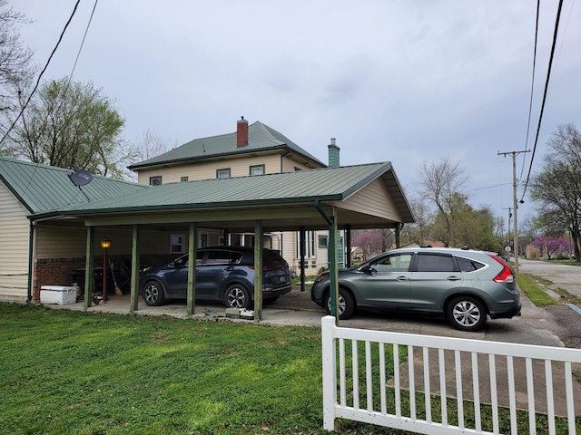 view of parking featuring a carport and a yard