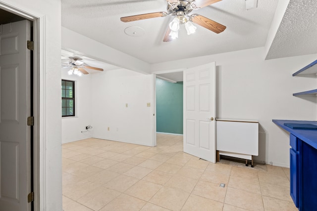 interior space featuring ceiling fan and a textured ceiling