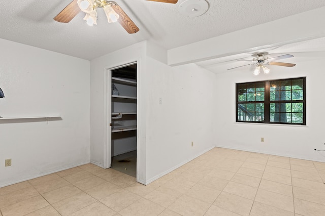 spare room featuring ceiling fan and a textured ceiling