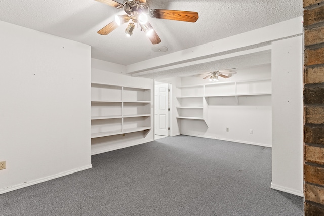 interior space with dark colored carpet and ceiling fan