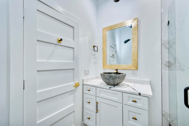 bathroom with walk in shower and vanity