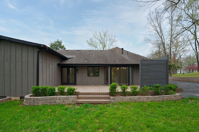 rear view of property featuring a lawn and covered porch