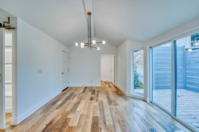 unfurnished dining area featuring light wood-type flooring, vaulted ceiling, and an inviting chandelier