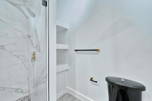 bathroom with built in features, toilet, an enclosed shower, and wood-type flooring