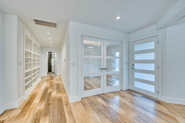 entrance foyer with french doors and light wood-type flooring