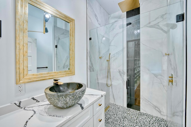 bathroom featuring vanity and a shower with shower door