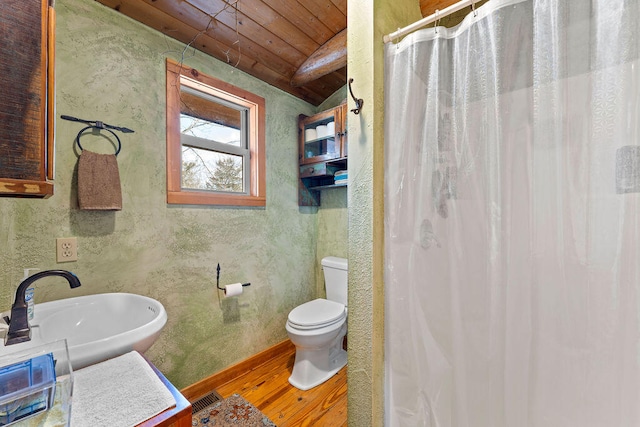 bathroom featuring lofted ceiling, wood-type flooring, wood ceiling, sink, and toilet