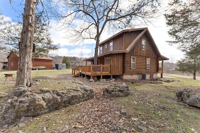 view of property exterior featuring central air condition unit and a wooden deck