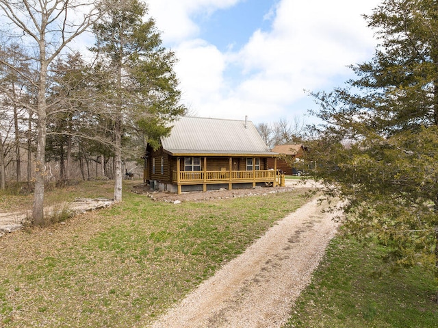 rear view of property with a lawn and covered porch