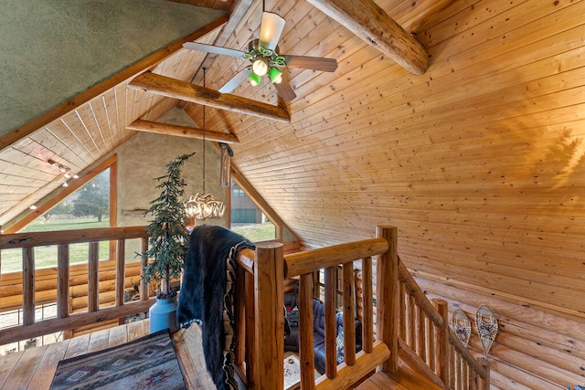 interior space featuring hardwood / wood-style flooring, vaulted ceiling with beams, and wood walls