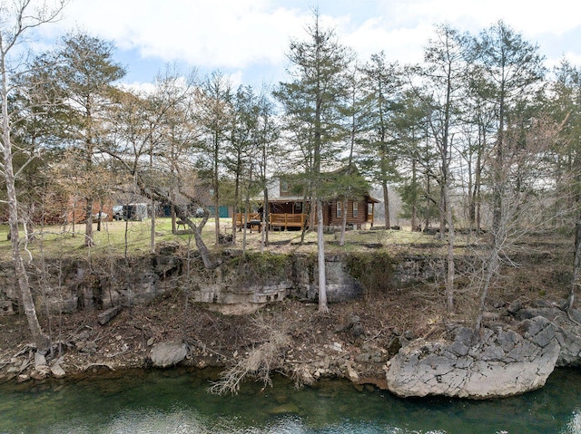 view of yard featuring a deck with water view