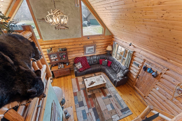 living room featuring a notable chandelier, wood ceiling, hardwood / wood-style floors, and log walls