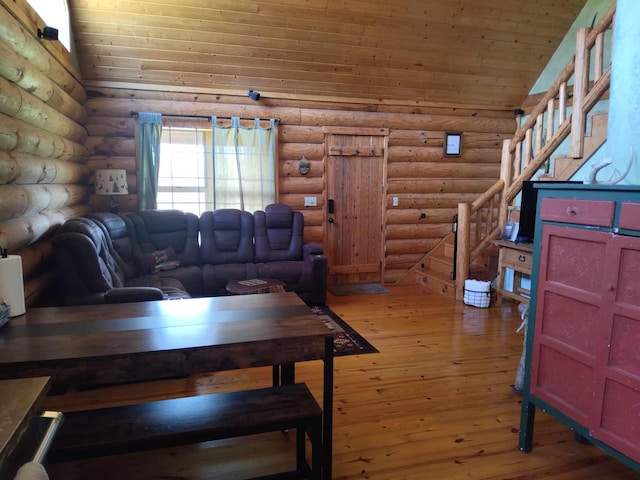 living room with light hardwood / wood-style flooring, wood ceiling, and log walls