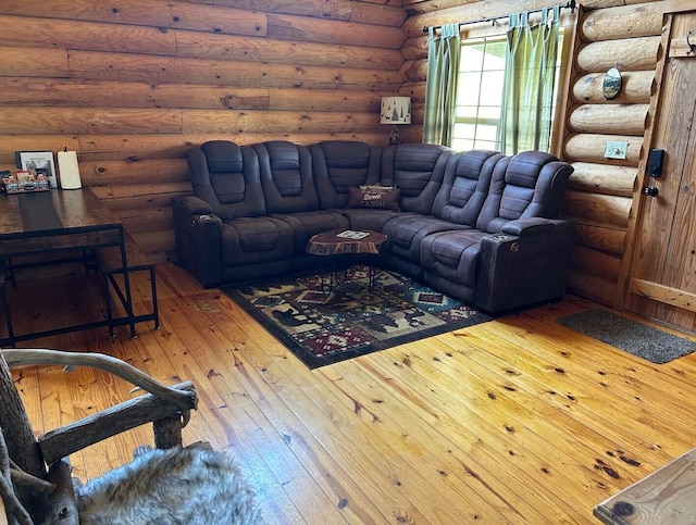 living room featuring hardwood / wood-style flooring and log walls