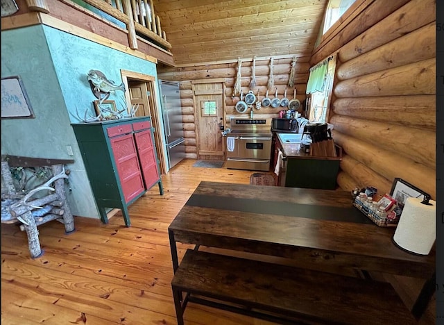 interior space featuring lofted ceiling, wood ceiling, rustic walls, and light hardwood / wood-style flooring