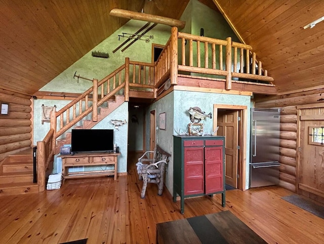 living room featuring hardwood / wood-style flooring, wood ceiling, high vaulted ceiling, and log walls