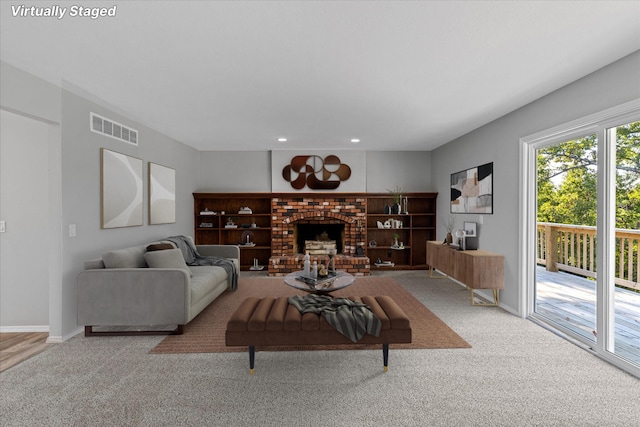 living room with carpet floors and a fireplace