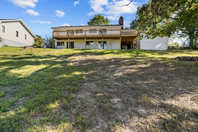 rear view of house with central air condition unit, a lawn, and a wooden deck