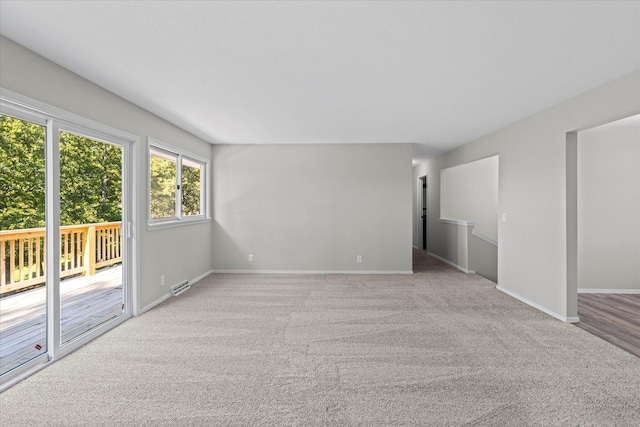 unfurnished room with light carpet