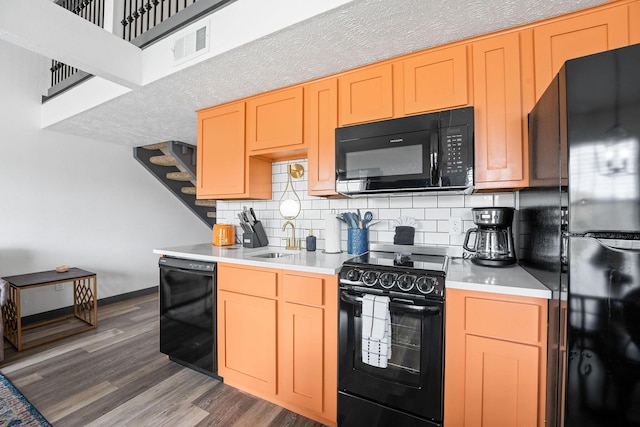 9 Scenic Ct Unit 9-9, Branson, MO 65616 - kitchen with light countertops, wood finished floors, a sink, decorative backsplash, and black appliances