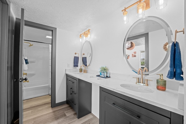 9 Scenic Ct Unit 9-9, Branson, MO 65616 - full bath featuring double vanity, wood finished floors, a textured ceiling, and a sink