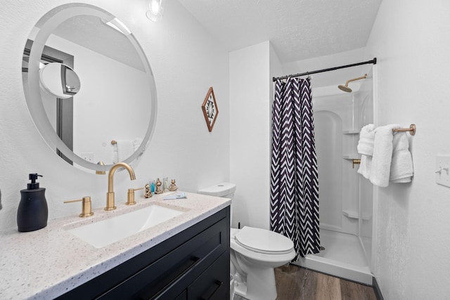 9 Scenic Ct Unit 9-9, Branson, MO 65616 - bathroom with wood finished floors, toilet, vanity, a textured ceiling, and a stall shower