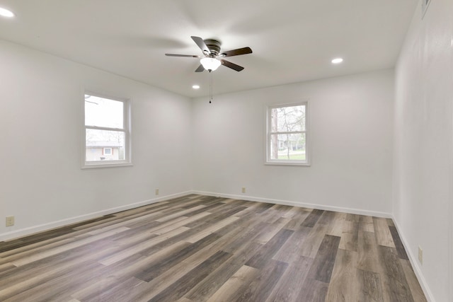 spare room featuring wood-type flooring and ceiling fan