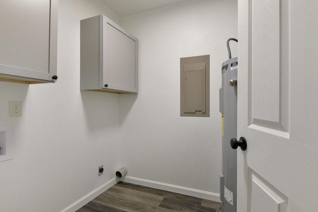 washroom featuring dark wood-type flooring, electric panel, baseboards, electric dryer hookup, and cabinet space