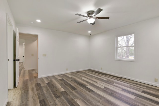 spare room with ceiling fan and dark hardwood / wood-style flooring